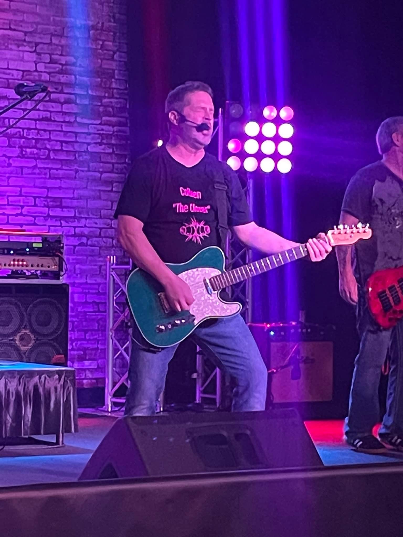 Chad on stage with purple lights